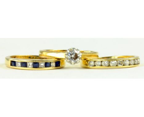 TWO DIAMOND RINGS IN GOLD, MARKED 18CT OR 750 AND A SAPPHIRE AND DIAMOND RING IN GOLD, MARKED 14K, 7.1G GROSS