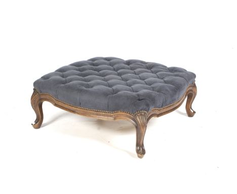 A Louis XV style stained beech button back large low upholstered foot stool. With blue faux suede covering, H30.5cm x W72cm.