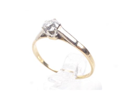 A vintage gold and diamond solitaire ring. The old cut stone approx. 0.33cts, claw set in white an an unmarked yellow gold D-