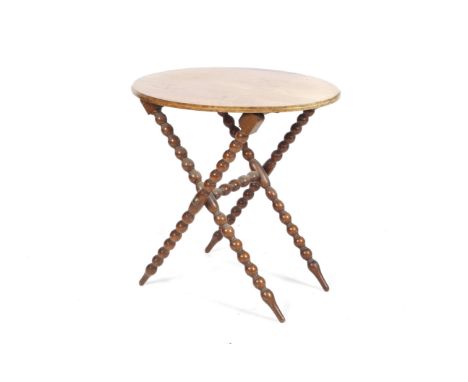 An 1877 walnut oval folding table. With bobbin turned X frame legs, inscription beneath reading 'S Babbage 17 No, 1877', poss