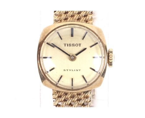 Tissot, Stylist, a lady's 9ct gold oblong bracelet watch, circa 1969. The brushed golden dial with raised black baton indicat