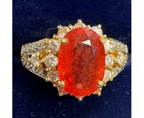 A Gems TV 18ct gold, orange sapphire and near colourless stone oval cluster ring. The oval mixed-cut sapphire probably beryil