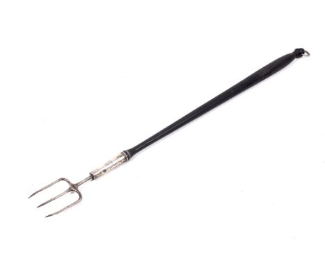 An in-part George II and later mounted toasting fork. The turned ebonised wood handle with a plated three-tine fork and ring 