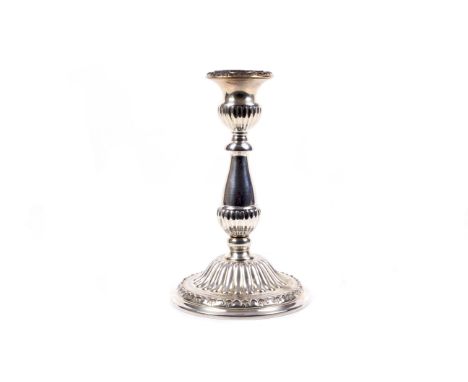 A Peruvan 'Sterling' round candlestick. With a fluted vase-shaped capital with a decorative border, a part fluted baluster st