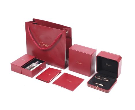 Cartier, a French 18ct gold 'Love collection' bangle. The rectangular section hinged bangle decorated with screws, Signed and