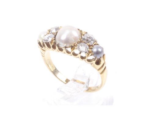 An Edwardian 18ct gold, half-pearl and diamond dress ring. Centred with a 7.2mm diameter half-pearl (untesteed) between pairs