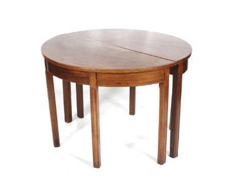 A pair of Sheraton style mahogany demi-lune console tables. With satinwood inlays, on straight legs with carved details. Meta