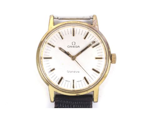 Omega, a gentleman's gold-plated and stainless steel round wrist watch, circa 1980. The brushed silvered dial with raised gil
