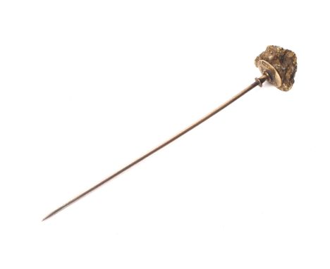 A late 19th century 'gold nugget' stick pin. The nugget primarily of quartz with coarse gold veining, approx. 11mm high, 15mm