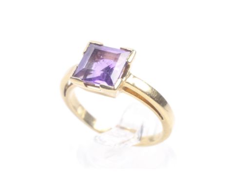 A vintage Continental square amethyst single stone ring. The step-cut stone in a four-corner mount to a flat-section shank st