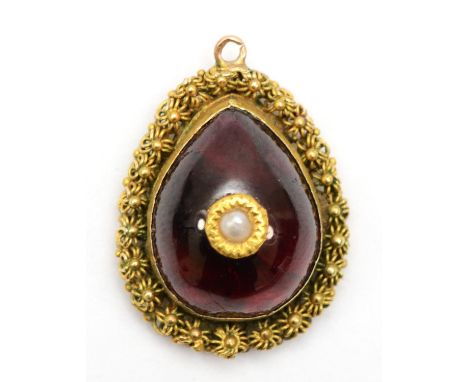 A gold mounted foil backed garnet centered with a seed pearl, 11 x 22mm, 3.3gm. 