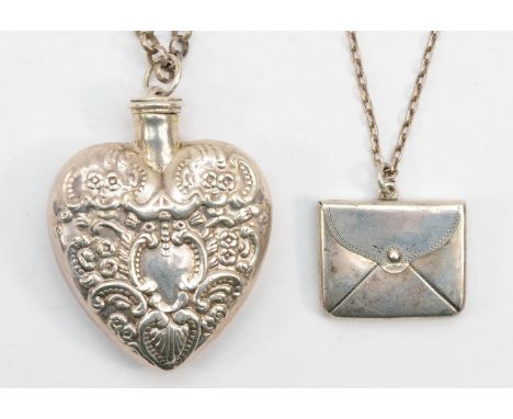 An Edward VII silver stamp case in the form of an envelope on chain, Birmingham 1905, together with a silver heart shaped per