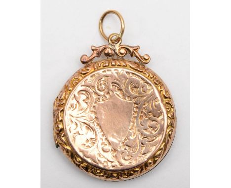 A Victorian 9ct gold front and back round locket with scrolling engraving decoration, 3cm. 