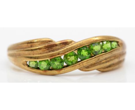 A 9ct gold channel set green stone ring, size V-W, 2.7gm. 