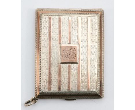 A George V silver and gold plated match book holder with engine turned decoration, Chester 1926, 6 x 4.5cm, 39gm. 
