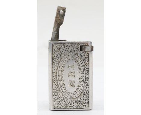 A rectangular metal petrol lighter with chased floral and scroll decoration, 4 x 2 x 2.5cm. 