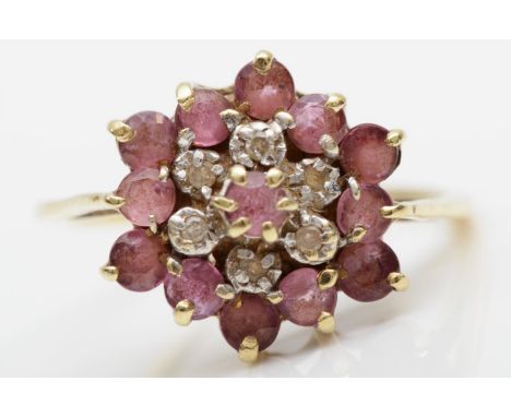 A 9ct gold ruby and diamond cluster ring, size N, 2.3gm. 