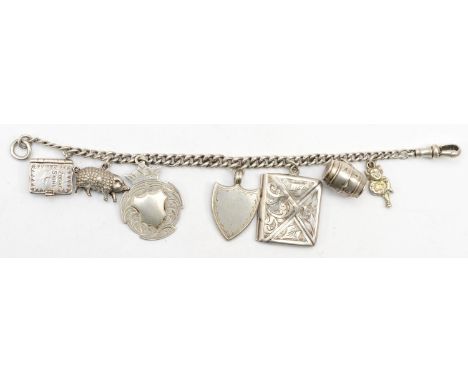 A silver charm bracelet, 17cm, with stamp case Chester 1909, 29gm. 