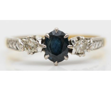 An 18ct gold sapphire and brilliant cut diamond three stone ring, size O, 2.9gm. 