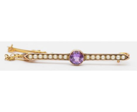 An Edwardian 9ct gold amethyst and seed pearl bar brooch with safety chain, 3.5cm, 1.9gm. 