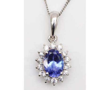 A 9ct white gold tanzanite and CZ cluster pendant, 17mm overall, chain, 1.6gm 