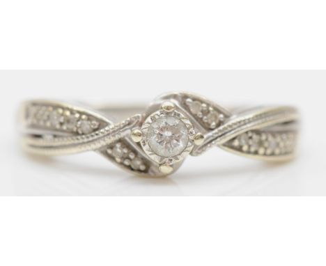 A 9ct white gold and brilliant cut diamond solitaire ring, stated weight 0.10ct, size H, 2.1gm. 