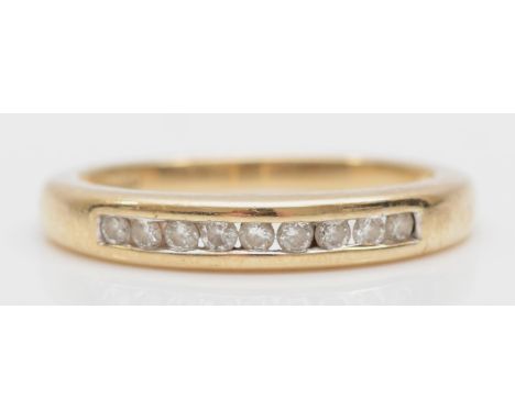 A 9ct gold and brilliant cut diamond channel set ring, size K - L, 2.1gm. 