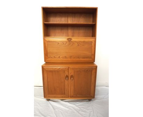 'ERCOL' BLONDE ELM CABINETwith an upper adjustable shelf above a fall flap revealing a fitted interior, with a pair of cupboa
