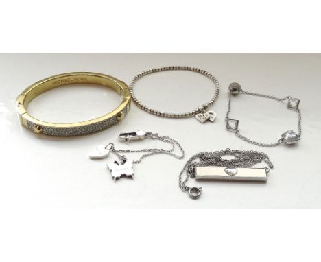 SELECTION OF FASHION JEWELLERYcomprising a Gucci butterfly and heart silver bracelet; a Michael Kors pave set gold tone bangl