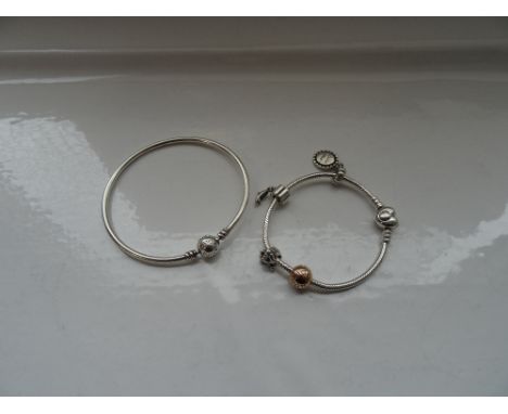PANDORA MOMENTS SILVER CHARM BRACELETwith heart shaped clasp, three Pandora charms and a Pandora clip; together with a Pandor