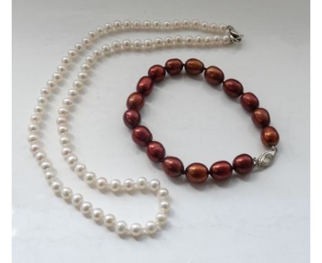 WHITE CULTURED PEARL NECKLACEwith silver clasp and approximately 42.5cm long; together with a brown cultured pearl bracelet w