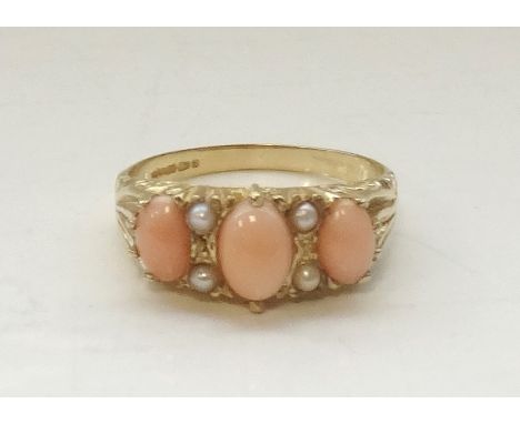 CORAL AND PEARL DRESS RINGthe three oval coral sections separated by seed pearls, on nine carat gold, ring size R