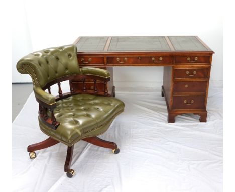 MAHOGANY TWIN PEDESTAL DESKwith an inset green leather top above an arrangement of nine cockbeaded drawers, standing on brack