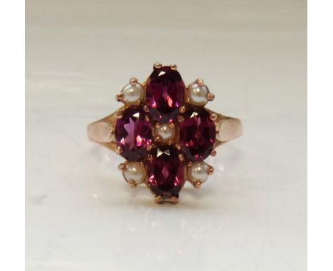 RHODALITE AND PEARL CLUSTER DRESS RINGthe four oval cut rhodalites interspersed with seed pearls, on nine carat rose gold sha