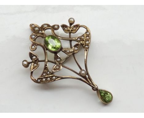 EDWARDIAN PERIDOT AND SEED PEARL HOLBEIN BROOCH/PENDANTin nine carat gold, the central oval cut peridot in seed pearl surroun