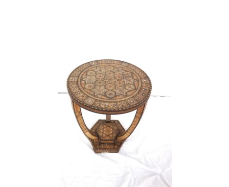 INDIAN SPECIMEN WOOD CIRCULAR OCCASIONAL TABLEthe an inlaid top with geometric stars and octagons with mother of pearl insert