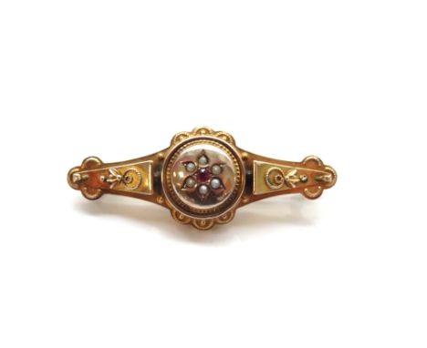 EDWARDIAN NINE CARAT GOLD MOURNING BROOCHthe front with central ruby and seed pearl cluster, the reverse with glazed panel re