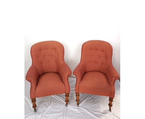 PAIR OF LATE VICTORIAN ARMCHAIRSwith shaped button backs and scroll arms above stuffover seats, standing on turned front supp