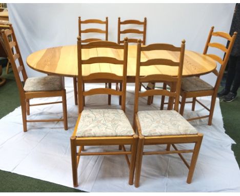 ERCOL WAXED PINE DINING TABLEwith an oval pull apart top revealing a fold out leaf, standing on turned supports, 135cm not ex