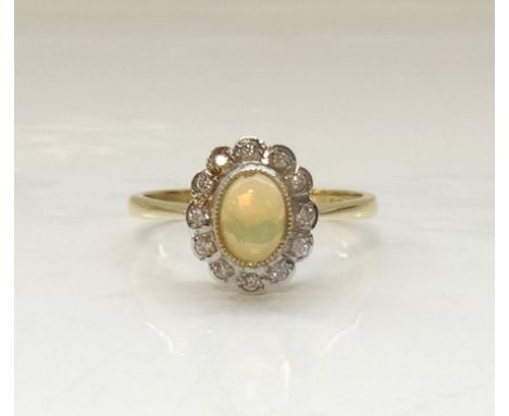 ETHIOPIAN OPAL AND DIAMOND CLUSTER RINGthe central oval cabochon opal in twelve diamond surround, on eighteen carat gold shan