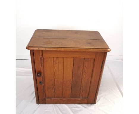 PITCH PINE LOW CUPBOARDwith a moulded top above a panelled door opening to reveal a shelf, with side carrying handles, 68.5cm