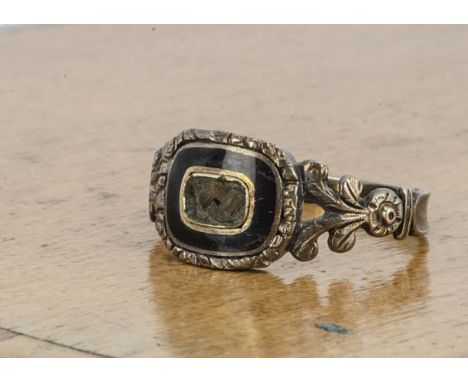 A William IV memorial ring, in black enamel with plaited hair panel (missing top), feathered and floral shoulders, bearing in