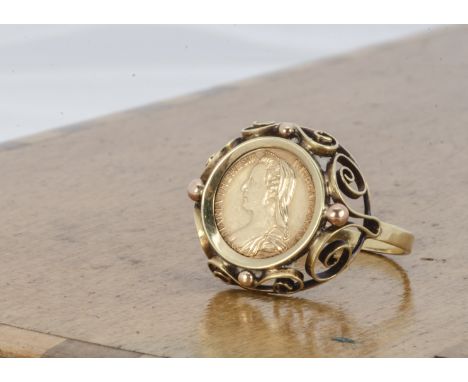 A continental Dutch coin ring, with Maria Theresa 14ct coin within a yellow metal scroll setting and plain shank with 585 sta