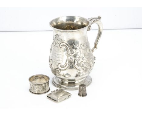 A 19th Century white metal tankard, with raised floral decoration and having inscription dating to 1864, 10.6ozt, together wi