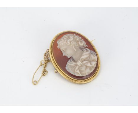A 19th Century hardstone oval cameo brooch, the sardonyx carved panel depicting a profile of a female within a fine rope twis