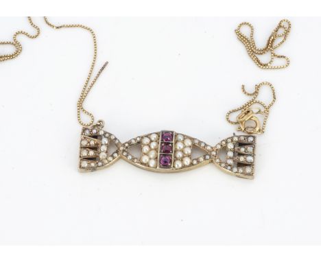 An Edwardian seed pearl and ruby sweetie pendant, in 9ct gold, 3.8cm x 1cm, 5.5g (chain af) 