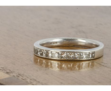 A Canadian diamond and gold half hoop eternity ring, all in 9ct gold, princess cuts in channel settings with hallmarked shank