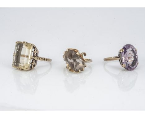 Three gem set lady's cocktail rings, including a citrine example with crown setting, ring size N, a fancy set smokey quartz, 