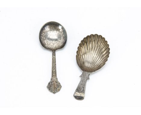 A Georgian period silver tea caddy spoon by L &amp; Co, together with an Arts &amp; Crafts period silver tea caddy spoon from