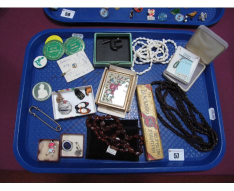 An Amber Bead Necklace, together with a long single strand seed necklace, a Kigu powder compact, with needlepoint detail, ena
